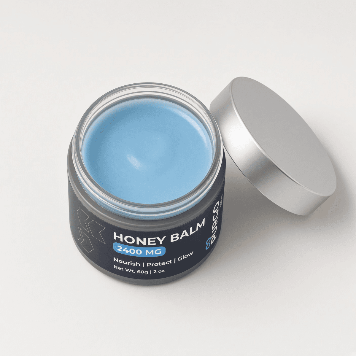Honey Balm jar held in hand